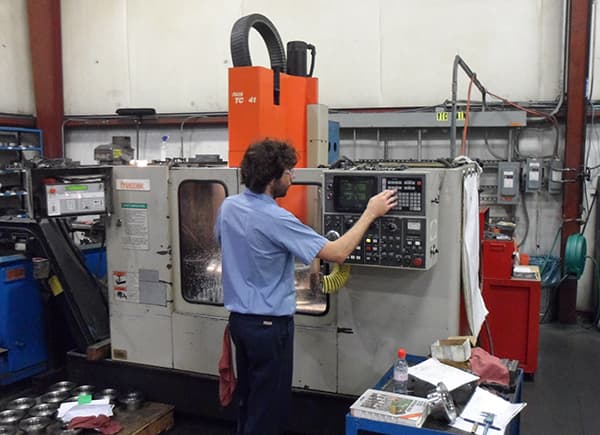 Operator programming a vertical machining center
