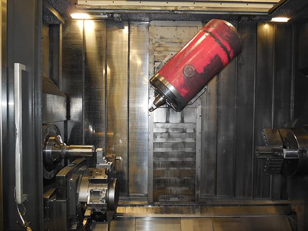 Inside a mill-turn center with a red part in the spindle