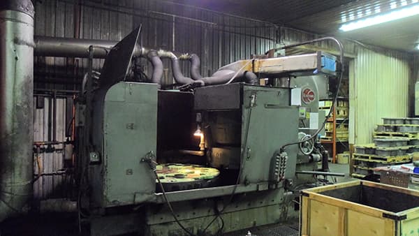 Vertical turret lathe in operation