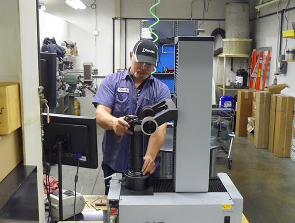 Technician using a height gage in the inspection lab